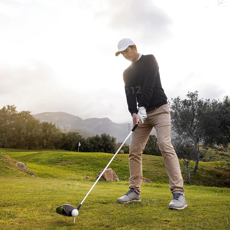 Man playing golf field with club