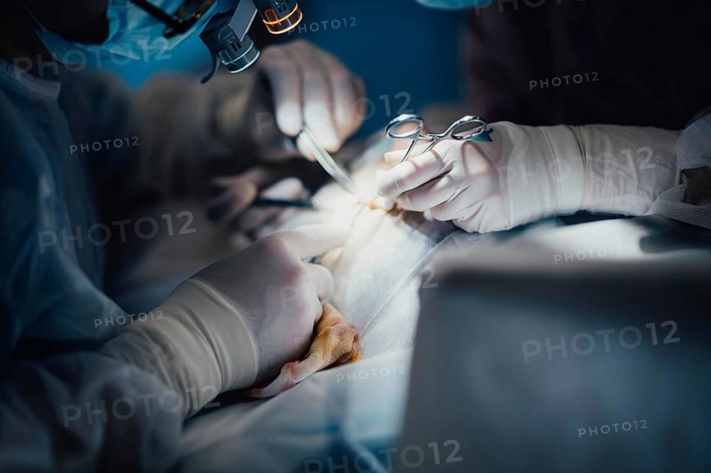 Surgeon operating on patient in operating room close up, surgical operation