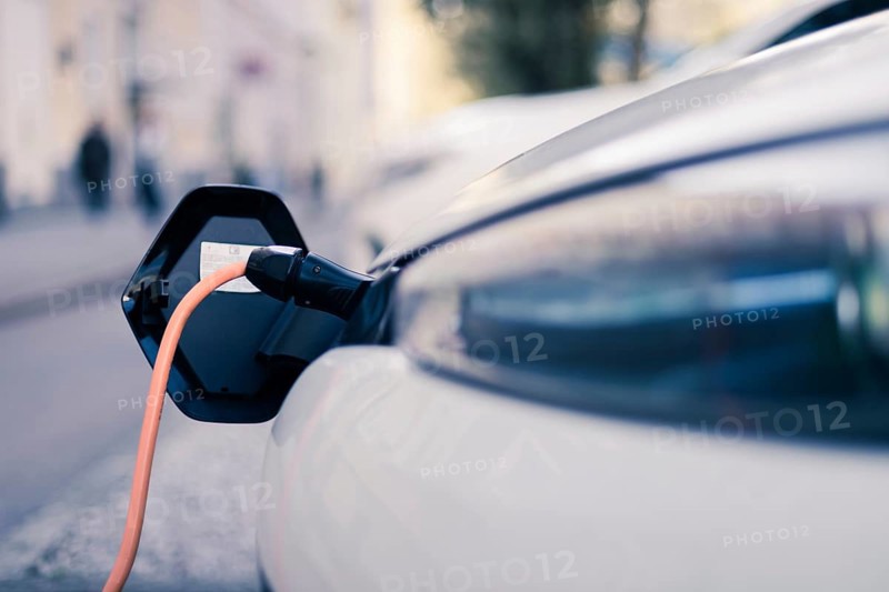 Electric car recharging with charge cable and plug leading to charge point