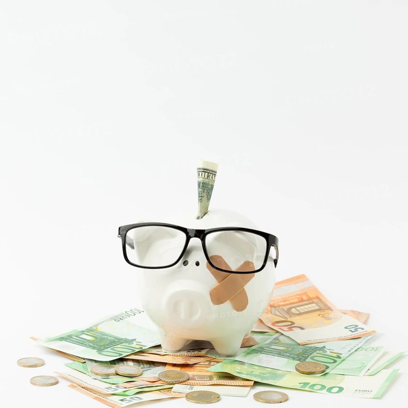 Broken piggy bank wearing glasses