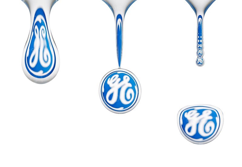 Closeup, macro sequence, water drop, dripping off of a sponge, logo of General Electrics reflected in the drop