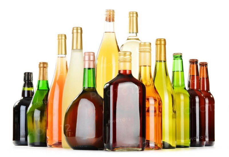 Bottles of assorted alcoholic beverages isolated on white background