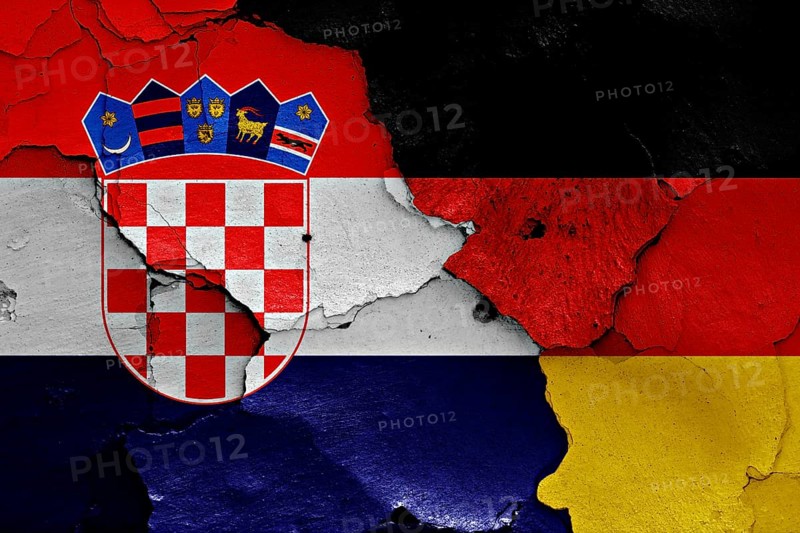 Flags of Croatia and Germany painted on cracked wall