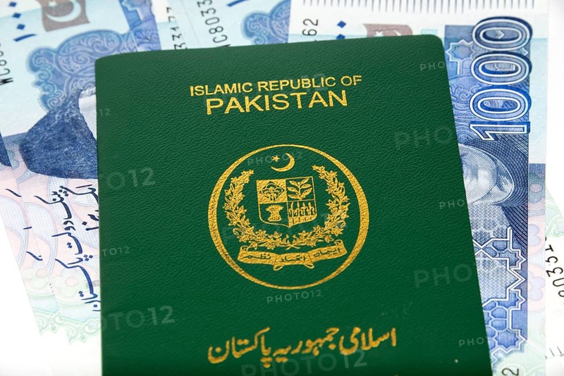 A Pakistani Passport on Currency notes in Pakistani Rupees