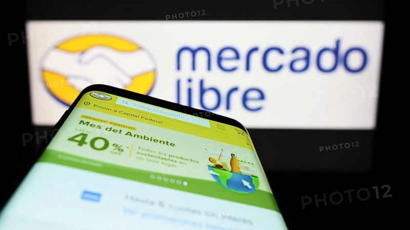 Stuttgart, Germany, 06-25-2022: Smartphone with webpage of Argentine e-commerce company Mercado Libre Inc. on screen in front of logo. Focus on top-left of phone display, Europe