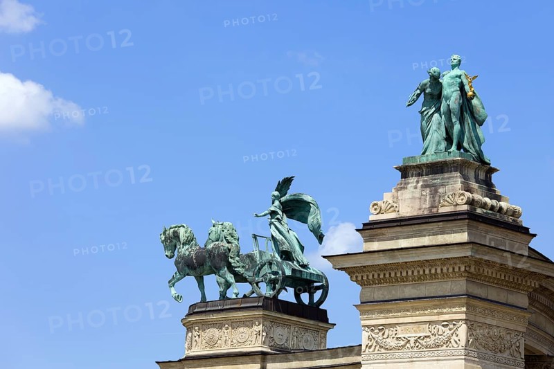 Millennium Monument on the Heroes Square in Budapest, Hungary with statues symbolizing Peace, Knowledge and Glory (top of right colonnade)
