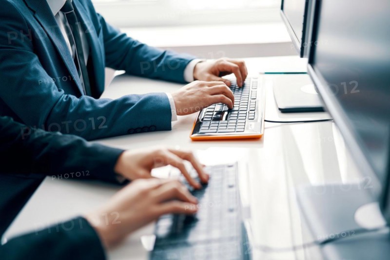 Business people working on laptop. People hands typing on laptop keyboard