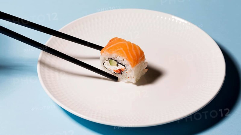 Plate with sushi roll chopsticks