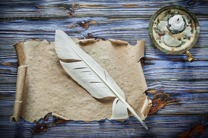 Vintage paper scroll feather chandelier on blue wooden background
