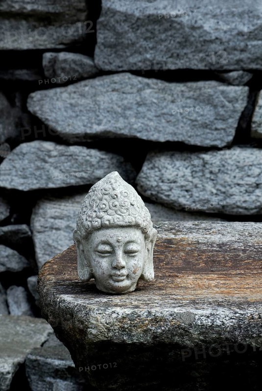 Buddha head on stone slab