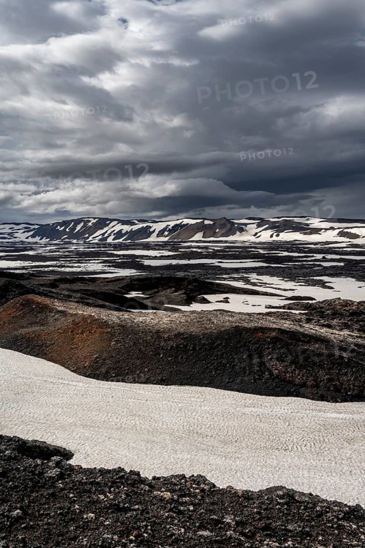 Snow-covered volcanic landscape with volcanic sand and petrified lava, crater of Askja volcano, Icelandic highlands, Iceland, Europe