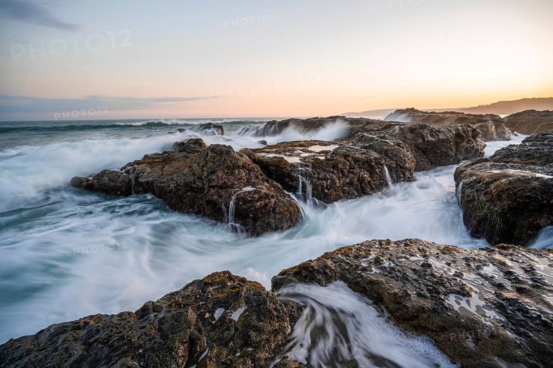 Waves washing over rocks by the sea, long exposure, coastal landscape at sunset, Playa Cocalito, Pacific coast, Nicoya Peninsula, Puntarenas province, Costa Rica, Central America