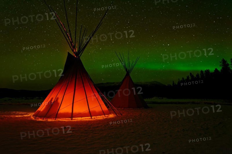 Two tents, tipis, Indian tents, front one illuminated from the inside, in a winter landscape, aurora borealis with stars in the sky, Yukon Territory, Canada, North America
