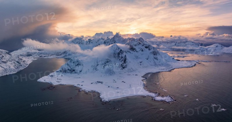 View of Flakstad and Skagsanden beach, snow-covered mountains and fjord at sunset, aerial view, Lofoten, Norway, Europe