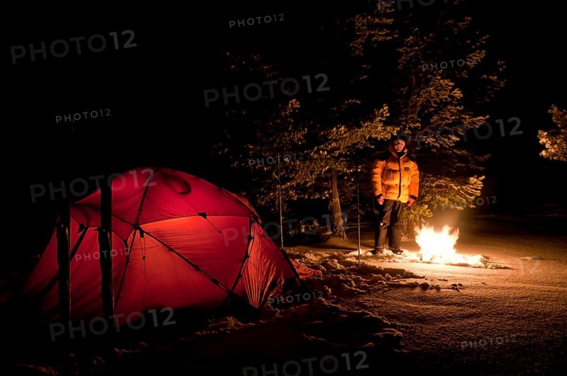 Tent in mountain landscape, Sarek National Park, Laponia World Heritage Site, Norrbotten, Lapland, Sweden, man warming himself by the campfire, Scandinavia, Europe