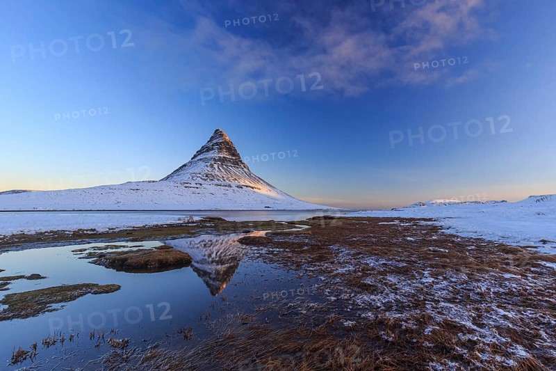 Pointed mountain reflected in fjord at low tide, snow, winter, morning light, Kirkjufell, Snaefellsnes, Iceland, Europe