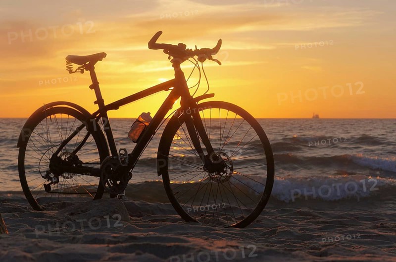 The silhouette of a Bicycle on the beach, Bicycle at sunset