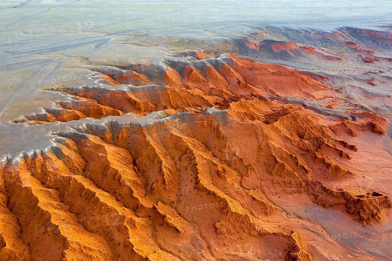 Aerial view of the Bayanzag flaming cliffs at sunset in Mongolia, found in the Gobi Desert