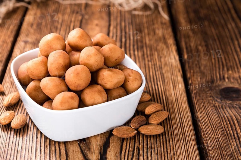Homemade Marzipan Potatoes (German cuisine) on rustic wooden background