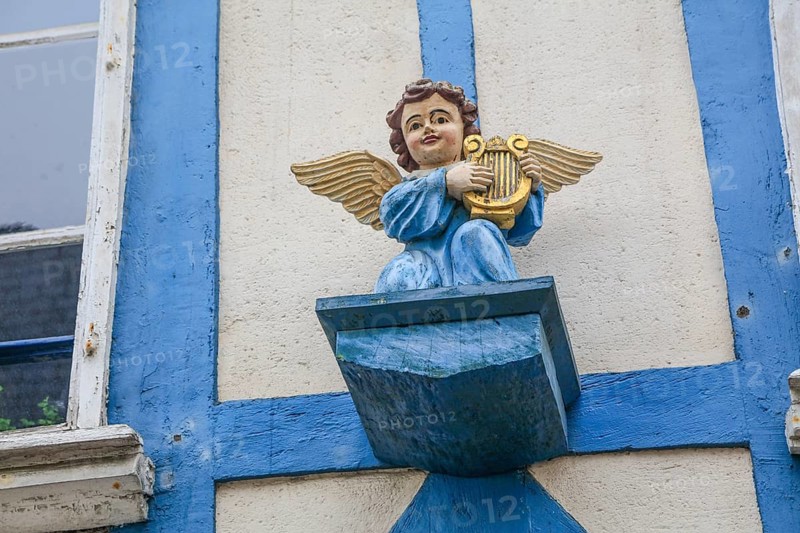 Carved angel with harp on the façade of a half-timbered house in Rue Rene Madec, painted blue, Quimper, Finistere Penn-ar-Bed department, Bretagne Breizh region, France, Europe