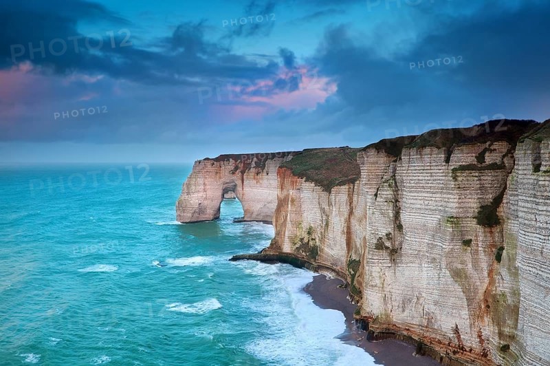 Rocky cliff in azure ocean waves, Etretat, Normandie, France, Europe