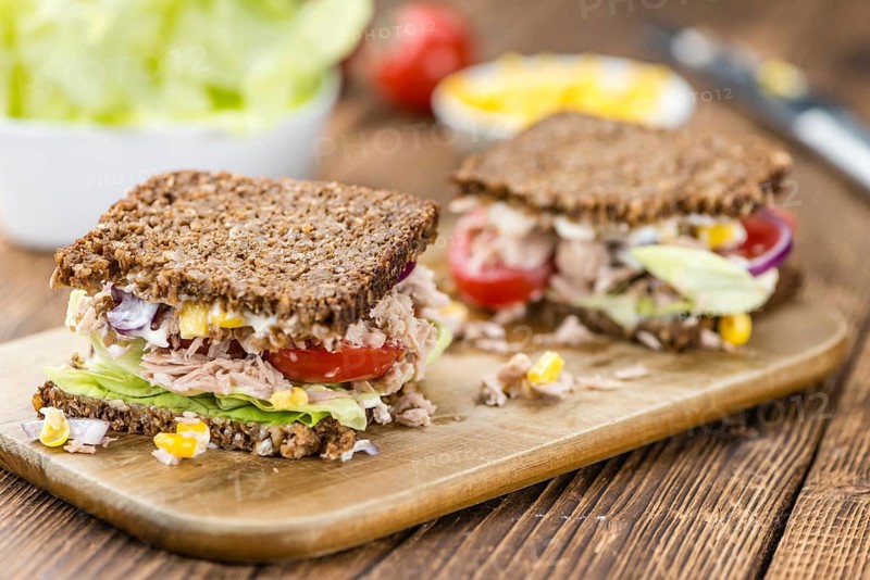 Old wooden table with Tuna sandwich (on wholemeal bread, selective focus)