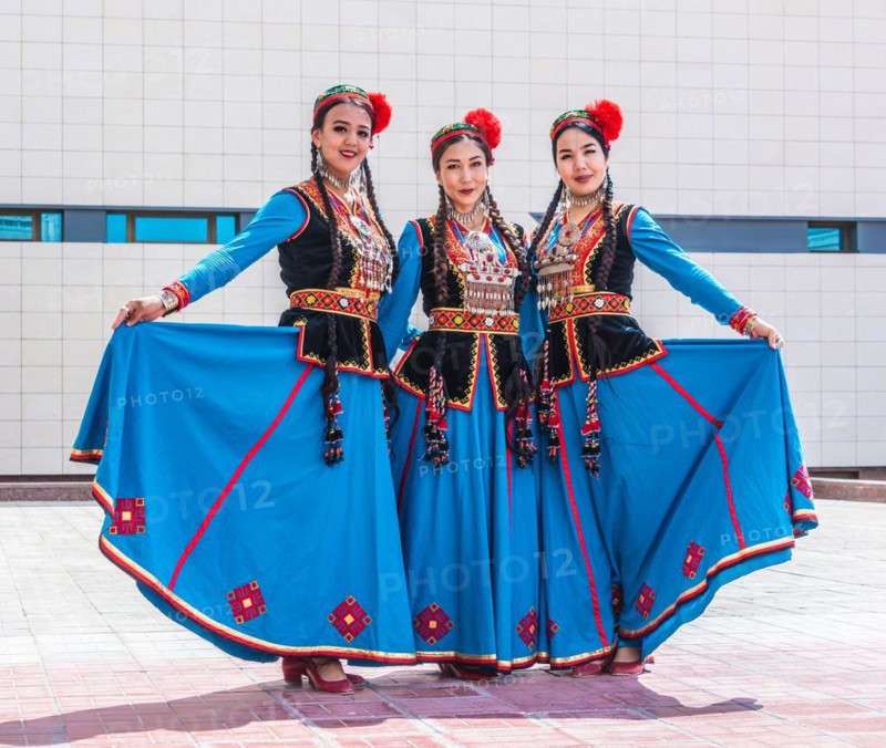 NUKUS, UZBEKISTAN - MAY 6, 2019: Three traditionally dressed folk dancers in Nukus, Uzbekistan, Asia