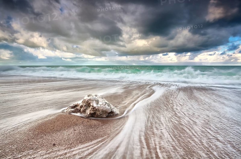 Clouded sky and ocean waves with long exposure, Etretat, France, Europe