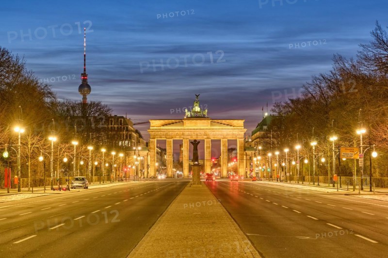 The famous Brandenburg Gate in Berlin with the TV tower at dusk