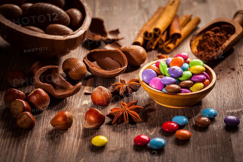 Assorted chocolate eggs for Easter on wooden background