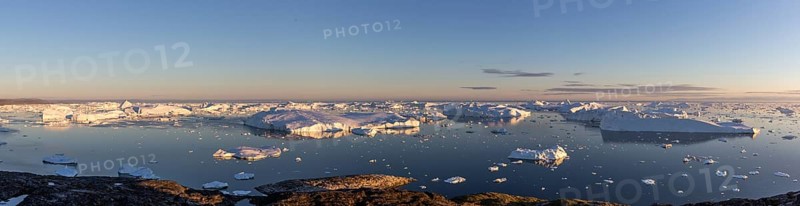Ilulissat, Greenland, July 7, 2018: Panoramic view of the Ilulissat Icefjord during midnight sun. Ilulissat Icefjord was declared a UNESCO World Heritage Site in 2004, North America