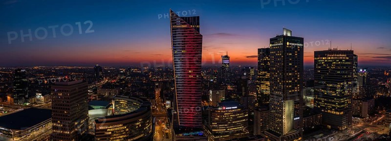 A panorama picture of the sun setting over Warsaw's business center and skyscrapers