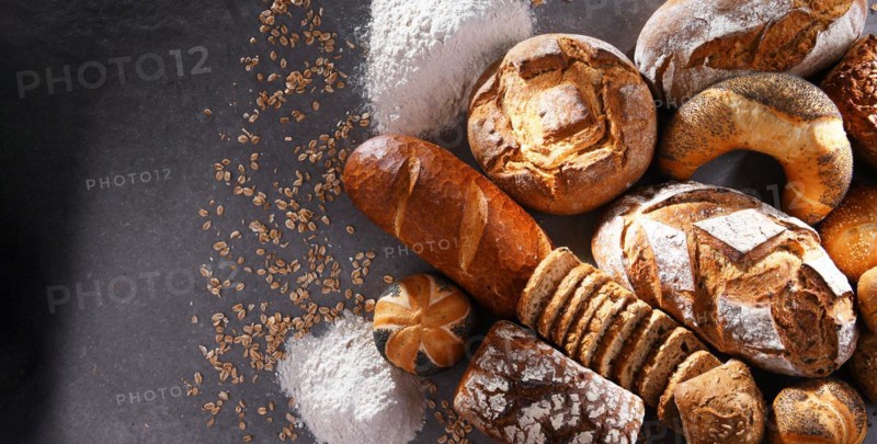 Assorted bakery products including loafs of bread and rolls