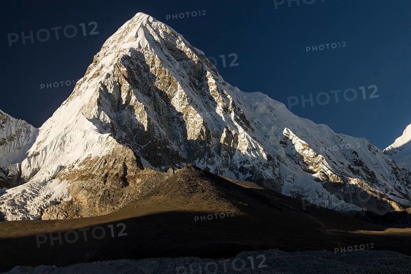 The seven-thousander Pumori and Kala Patthar, 5645m, the popular trekking peak and the Mount Everest viewpoint below it, seen late in the afternoon on a clear autumn, post-monsoon day. Khumbu, the Everest Region, Himalayas. Sagarmatha National Park, the UNESCO World Heritage Site. Solukhumbu, Nepal, Asia