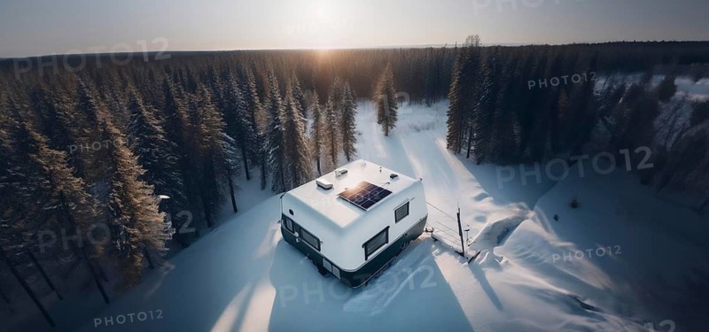 Trailer outdoors in winter in the forest with a solar panel on the roof. The concept of life outside civilization, AI generated
