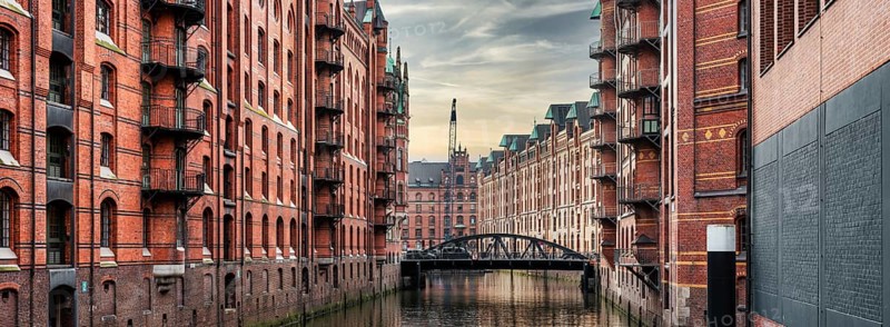 panoramic view of canal and historic buildings in old warehouse district Speicherstadt in Hamburg, Germany, Europe