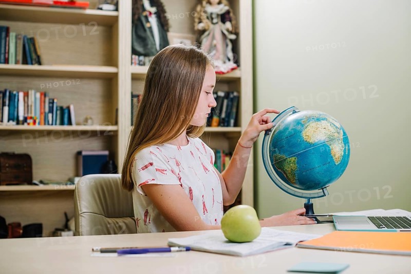 Student posing with globe table