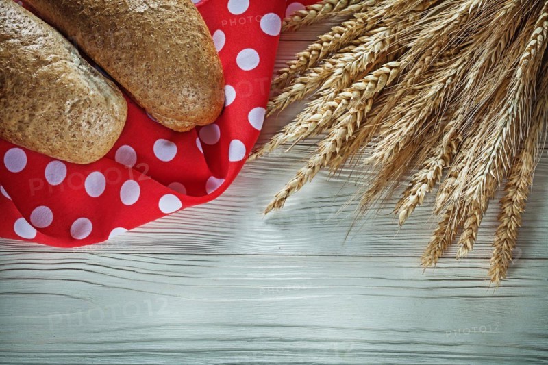 French bread wheat ears red napkin on white board