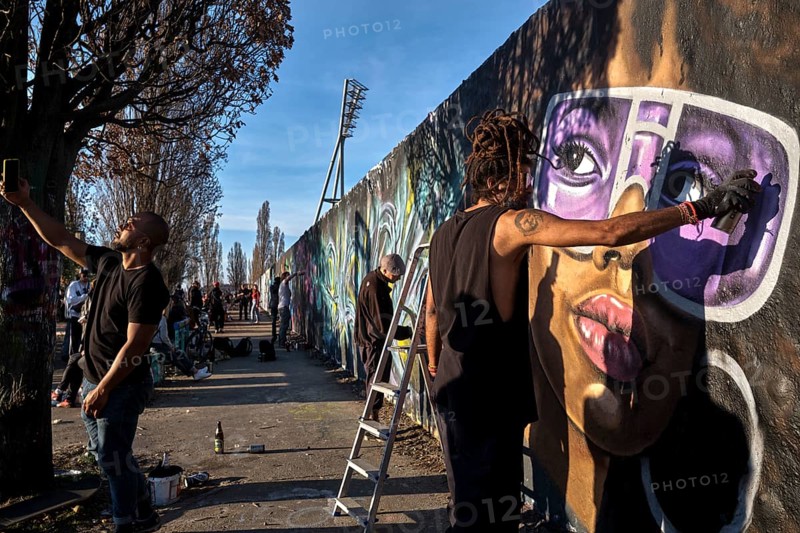 Germany, Berlin, 27. 03. 2022, Sunday afternoon Mauerpark, graffiti wall, graffiti artist Eme Freethinker at work, mobile phone photo, Europe