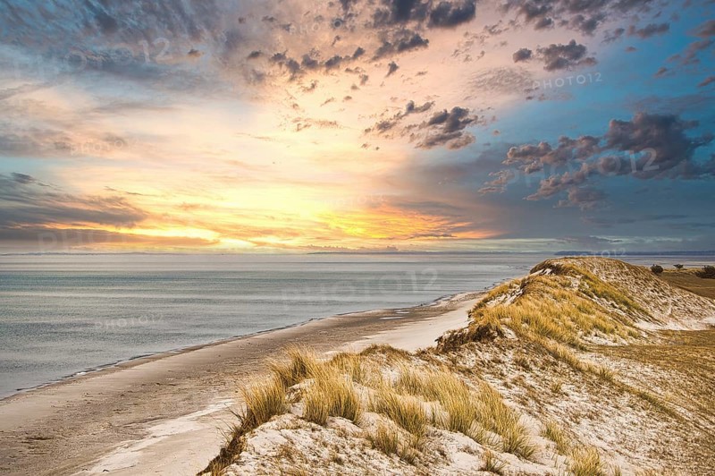 Dramatic sunset at the high dune on the darss. Viewpoint in the national park. Beach, Baltic Sea, sky and sea. Nature shot in Germany