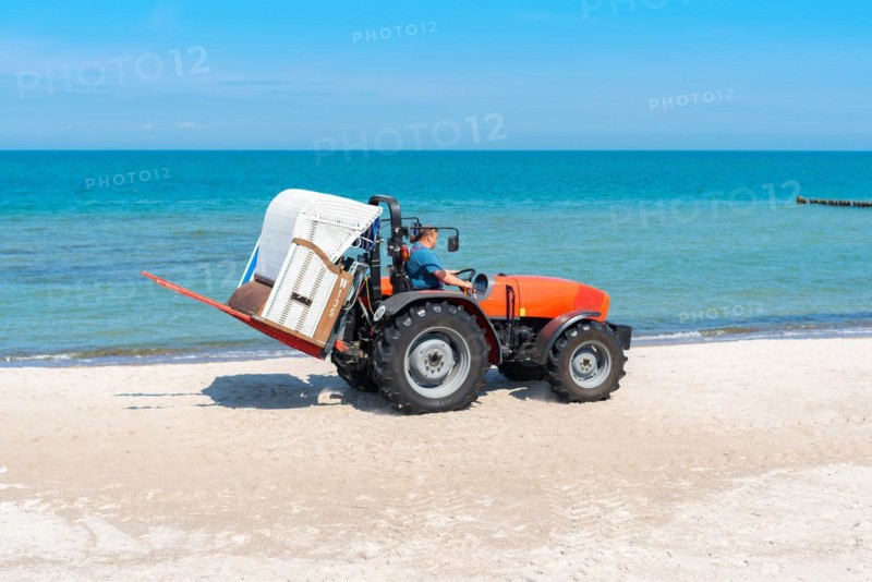 The beach chair rental place their baskets by tractor on the beaches of the Baltic Sea near Graal M