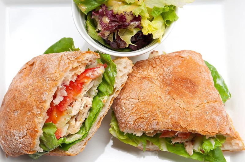 Italian ciabatta panini sandwich with chicken and tomato