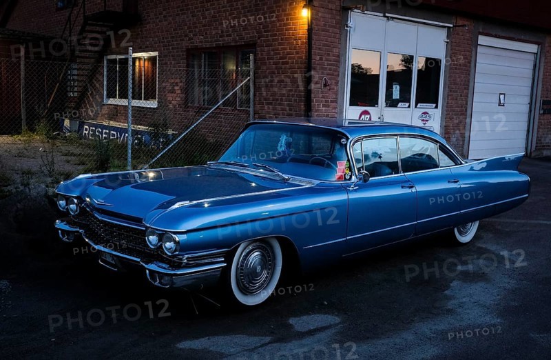American classic car, blue Cadillac in front of red brick building, industrial area, night shot, Rättvik, Dalarna, Sweden, Europe