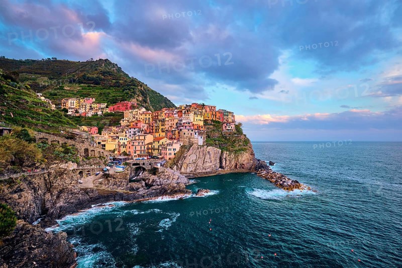 Manarola village popular european italian tourist destination in Cinque Terre National Park UNESCO World Heritage Site, Liguria, Italy on sunset