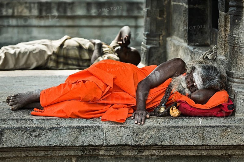 TIRUVANAMALLAI, INDIA, JANUARY 7, 2010: Sadhu, religious ascetic or holy person, sleeping in Hindu temple Arunachaleswar. Tiruvanamallai, Tamil Nadu, India, Asia