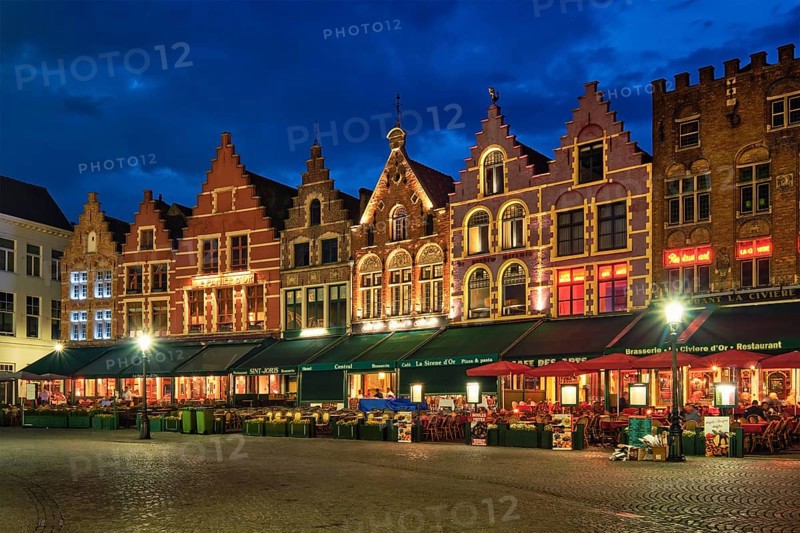 Bruges, Belgium, May 29, 2018: Bruges Grote markt square famous tourist place with many cafe and restaurants in the evening night twilight, Europe