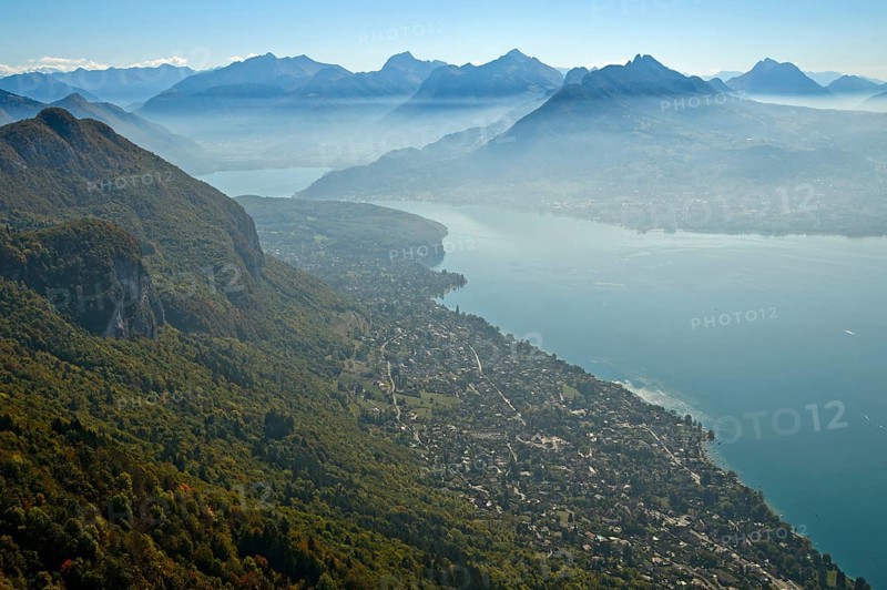 View from the summit of Mont Baron over the village of Veyrier-du-Lac to Lac dAnnecy in autumn mist to the chain of peaks of the Savoy Alps, Lake of Annecy, Annecy, Haute-Savoie, France, Europe