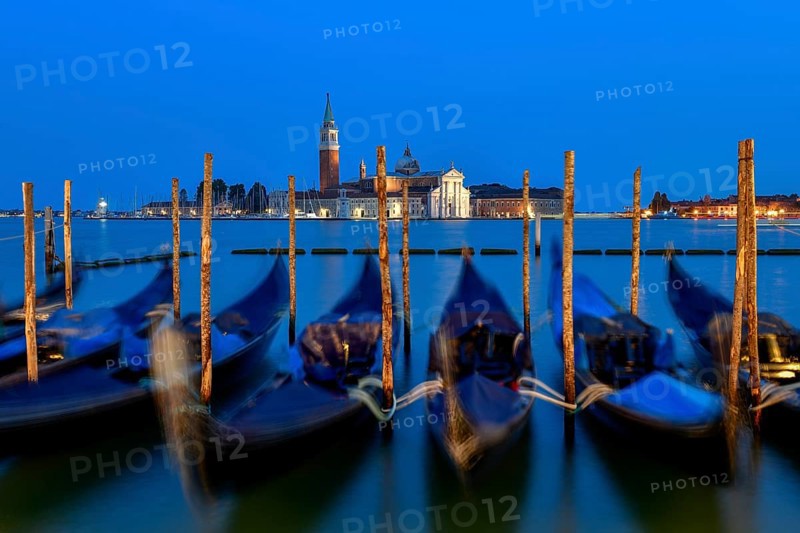Venetian gondolas near St. Mark's Square in the evening light, blue hour, in the background the monastery of San Giorgio Maggiore, district of San Marco, Venice, Veneto region, Italy, Europe