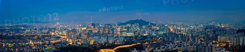 Panorama of Seoul downtown cityscape illuminated with lights and Namsan Seoul Tower in the evening view from Inwang mountain. Seoul, South Korea, Asia