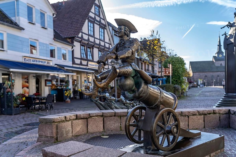 Munchausen figure The ride on the cannonball at the Munchausen fountain in Bodenwerder, Lower Saxony, Germany, Europe